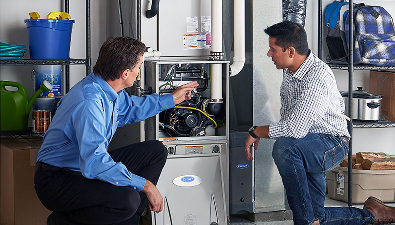 Technician evaluating a furnace for repair or replacement in San Dimas