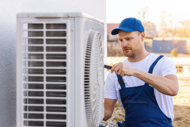 HVAC technician servicing an outdoor air conditioner in San Dimas