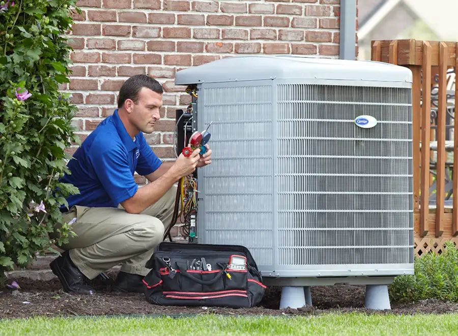 HVAC technician inspecting an outdoor AC unit in San Dimas